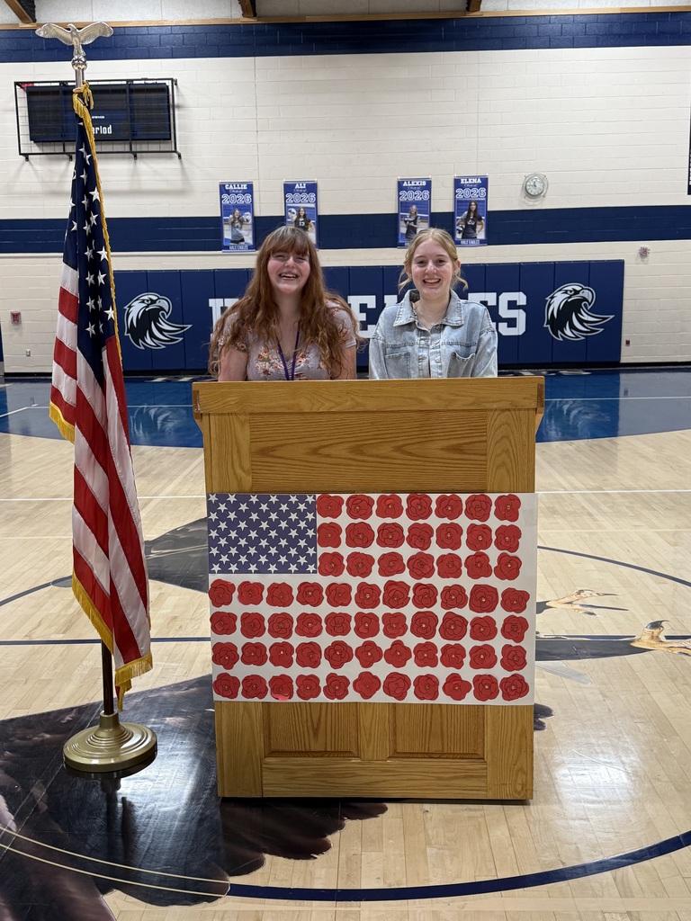 Two girls standing at podium