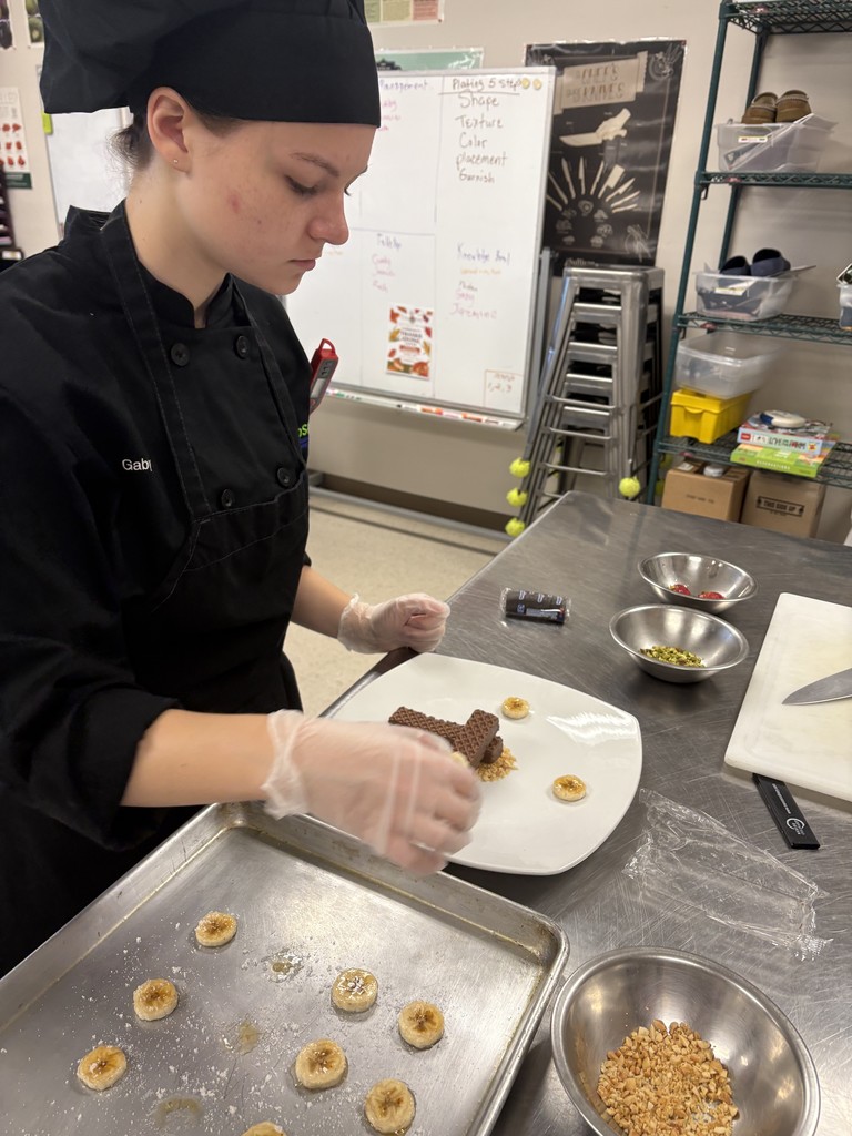 Culinary student working on plating