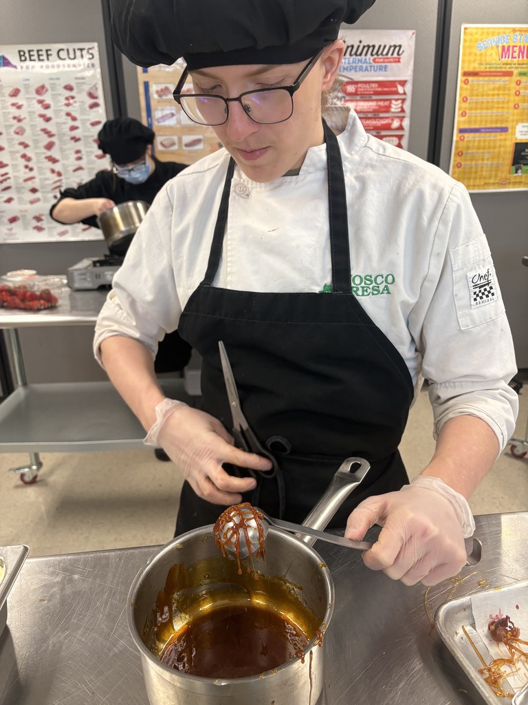 culinary student with a pot of carmel