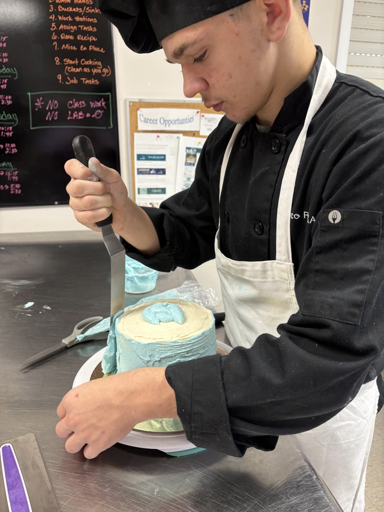 student icing a cake
