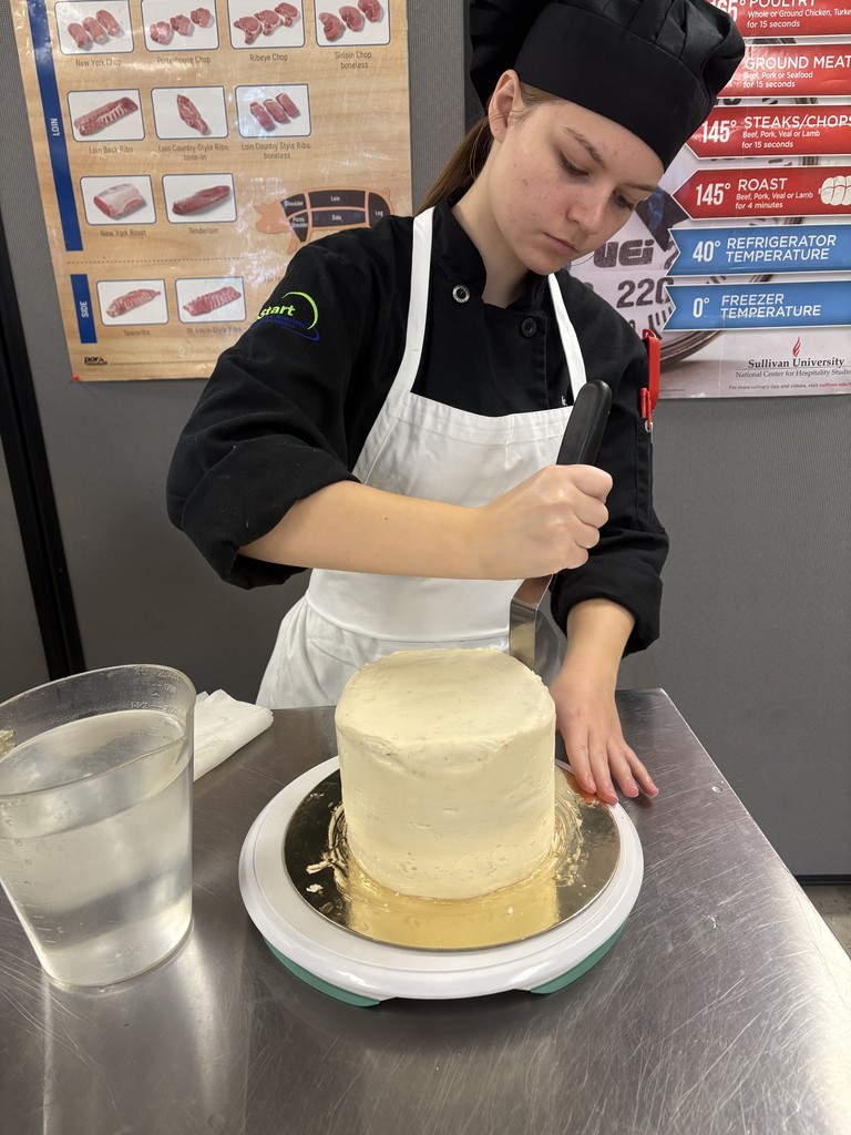student icing a cake