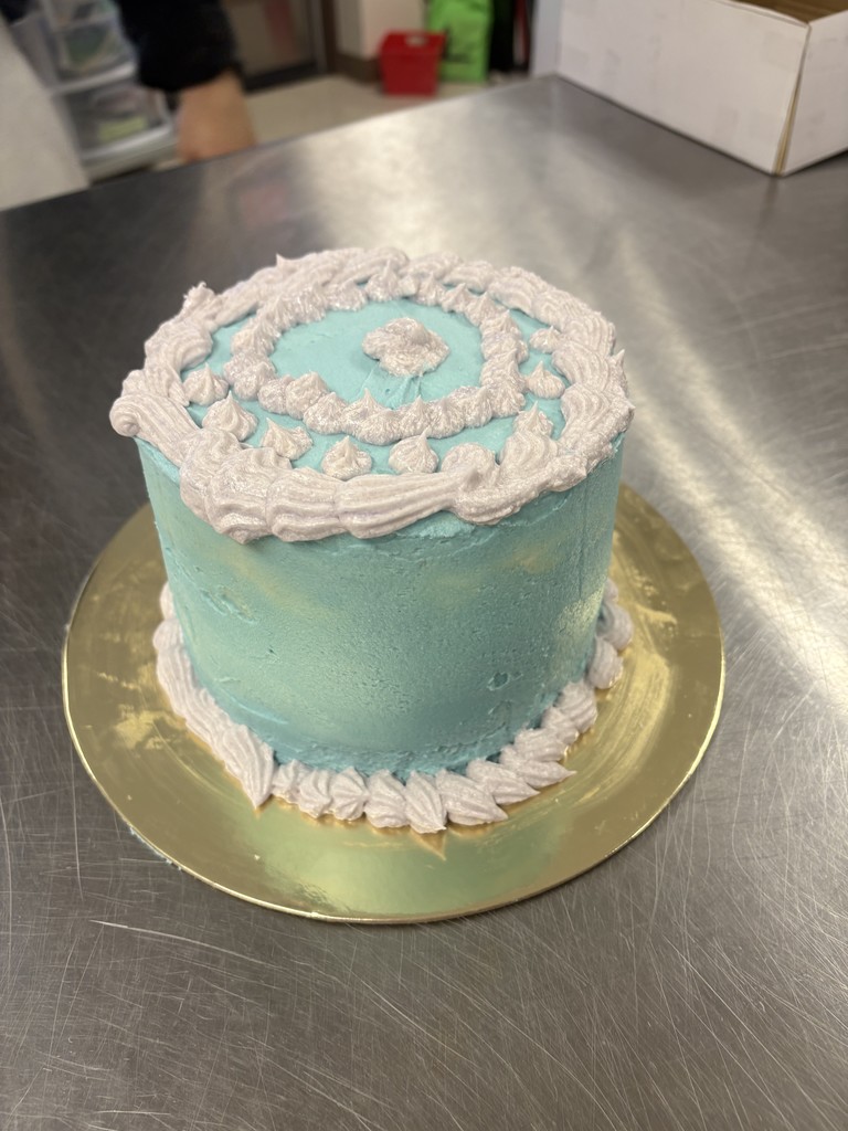 cake with light blue and white frosting