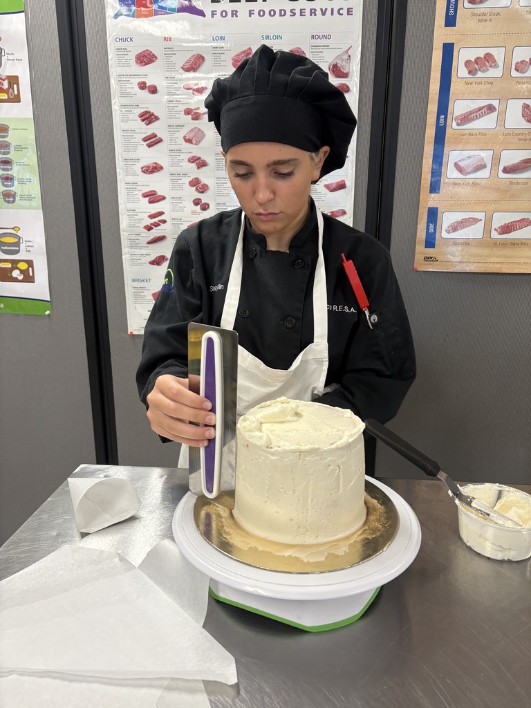 student icing a cake
