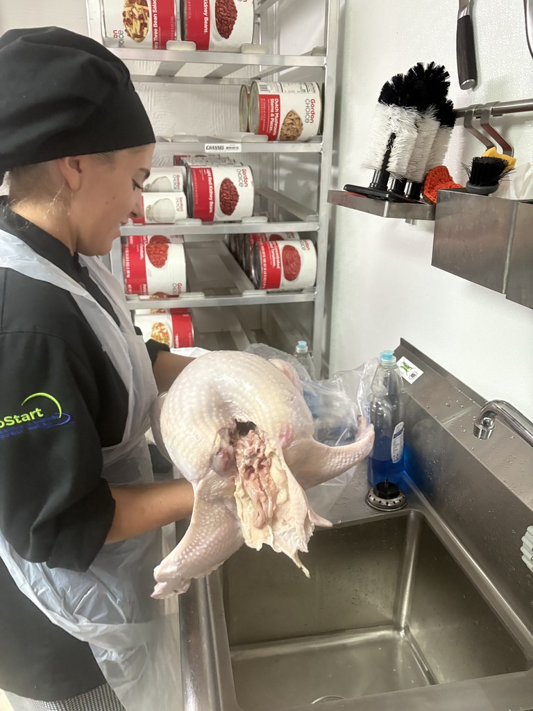 student preparing turkey