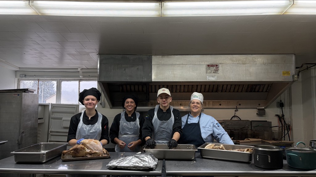 3 student chefs with their teacher