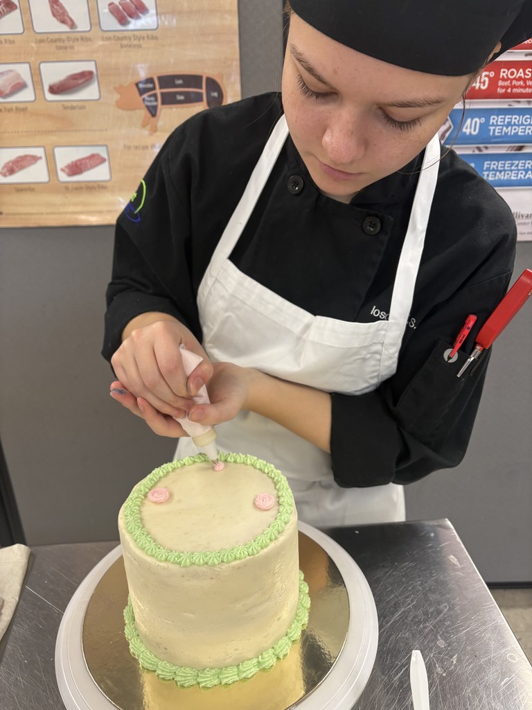 student decorating cake