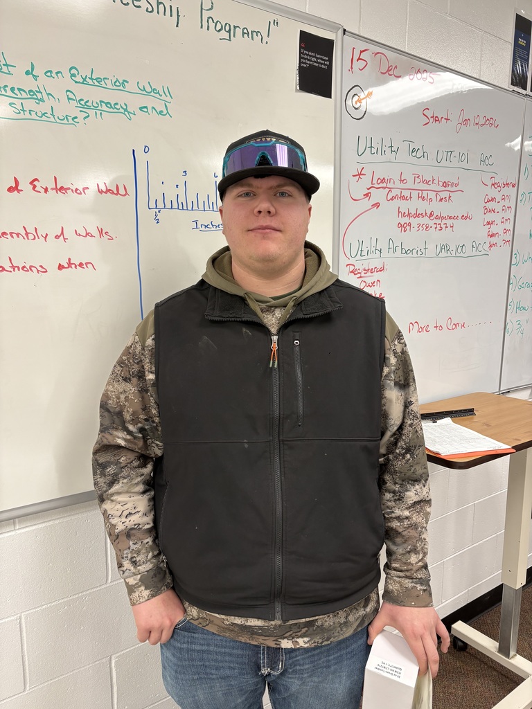 student standing in front of white board