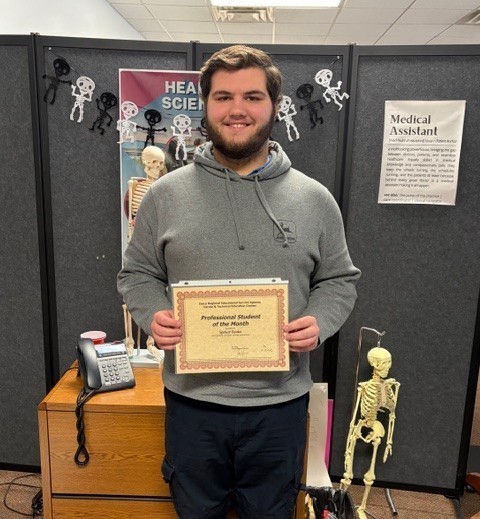 boy holding certificate