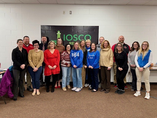 group of people standing in line for a photo