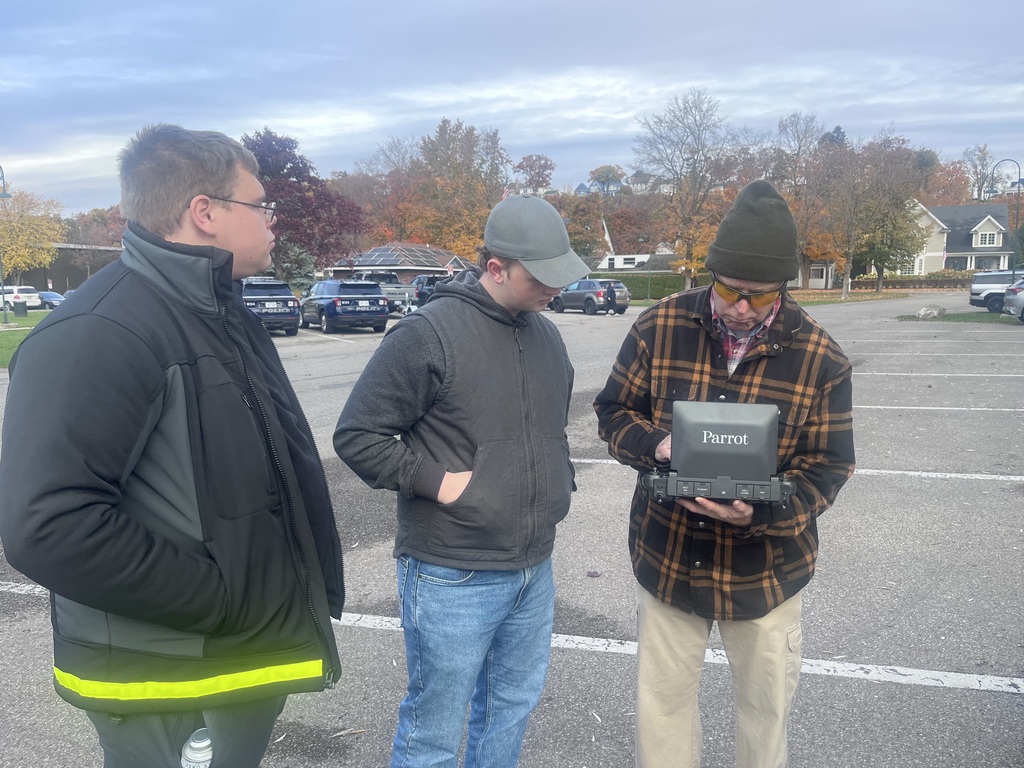 Students working with drone operator