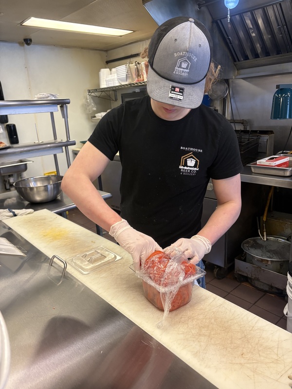 Boy working with tomato slices