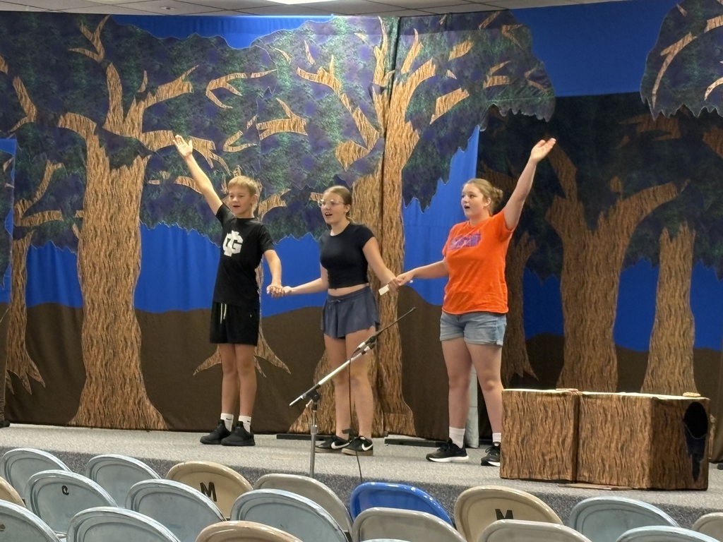 3 students on stage 