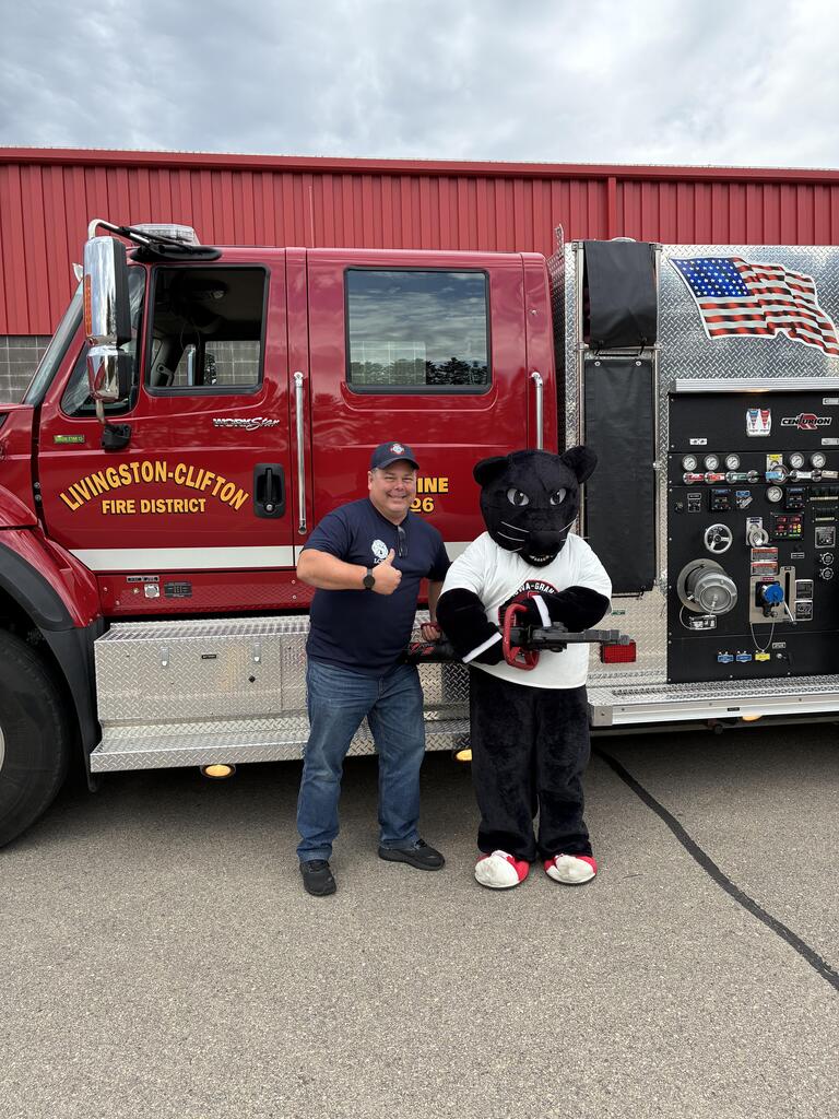 Zach Hake posing with the Panther in front of the Livingston-Clifton Fire Truck.