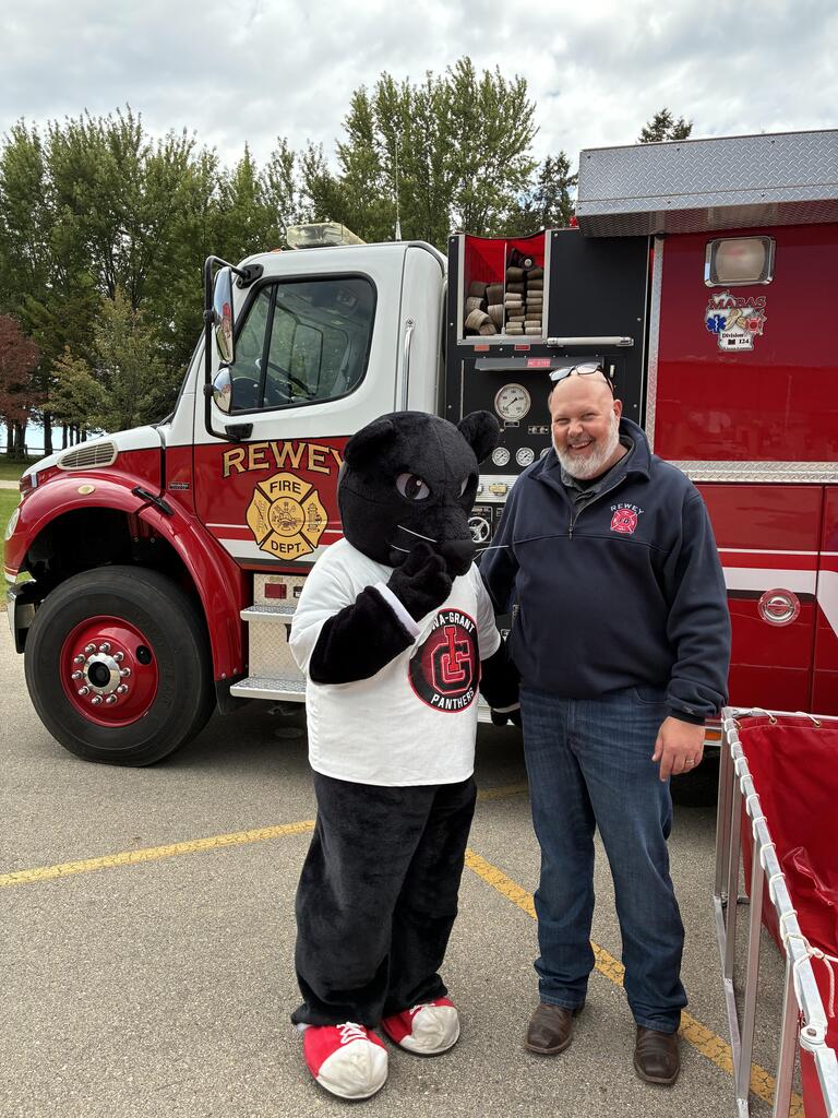 Picture of the Panther in front of a Rewey fire truck with Mitch Schauff.
