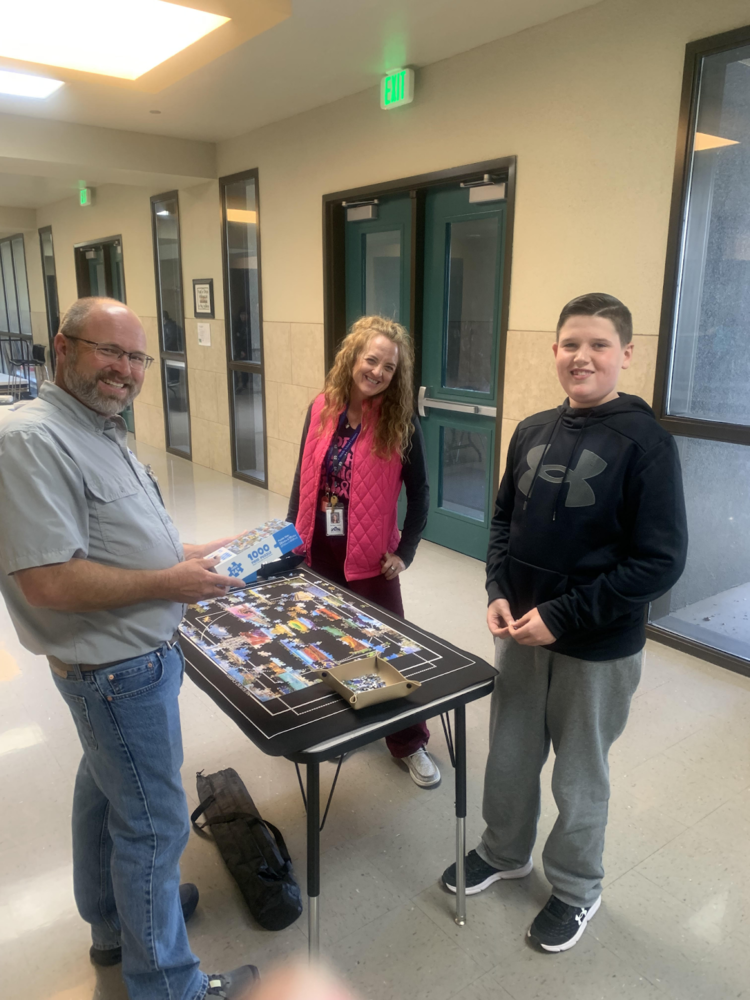 CVMS counselor, custodian, and student displaying Game Club