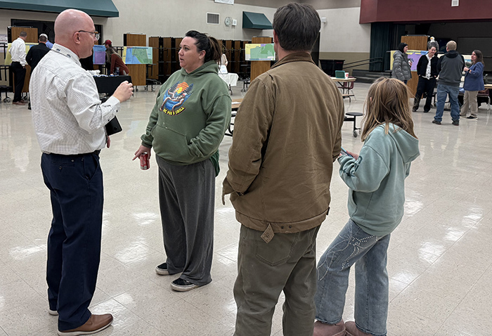 Parents speak to business administrator Todd Hess at the Cedar Middle School open house.