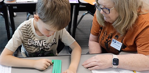Woman helping a boy with math