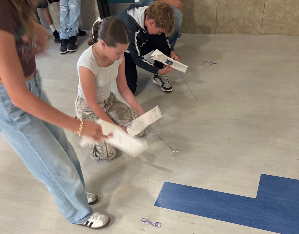 students racing skimmers