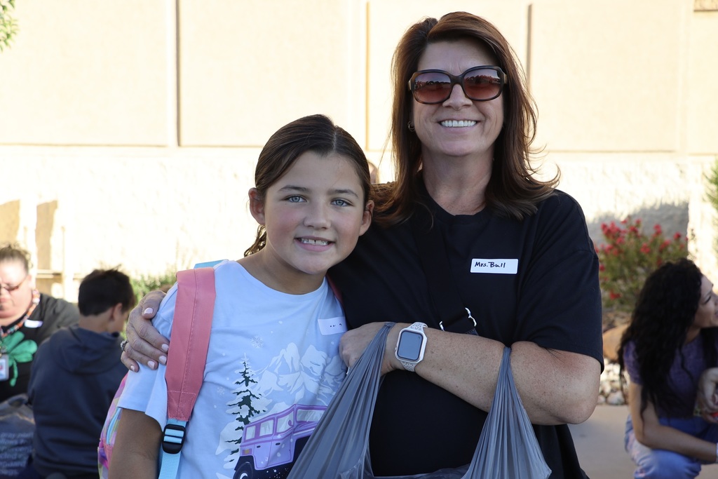 A volunteer poses with a student.