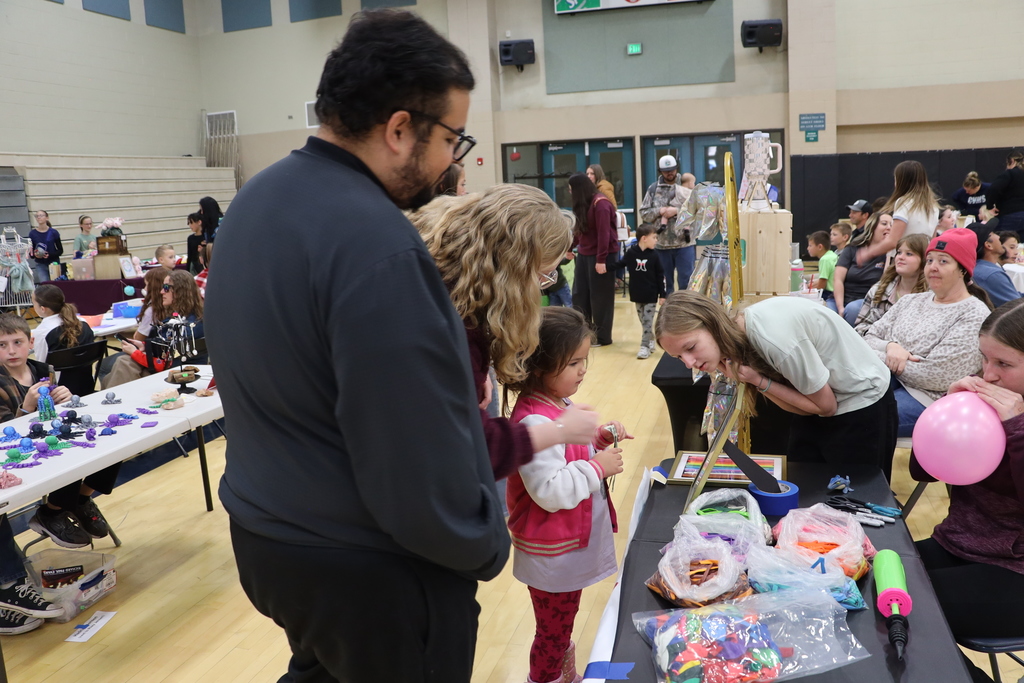 A child considers what to buy at a vendor booth.