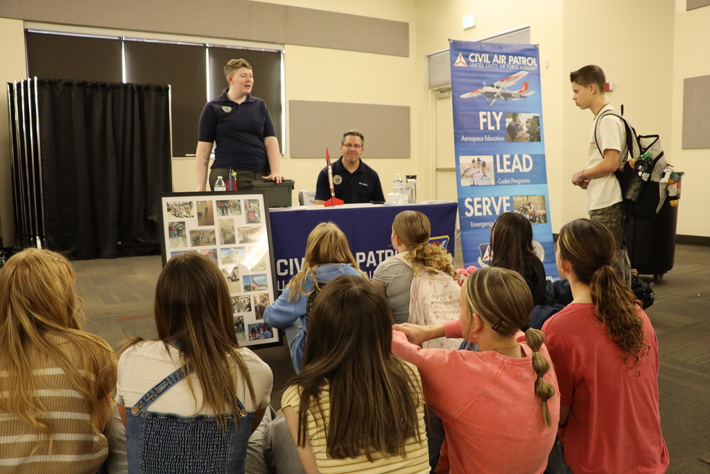 Representatives from the Civil Air Patrol speak with middle school students.