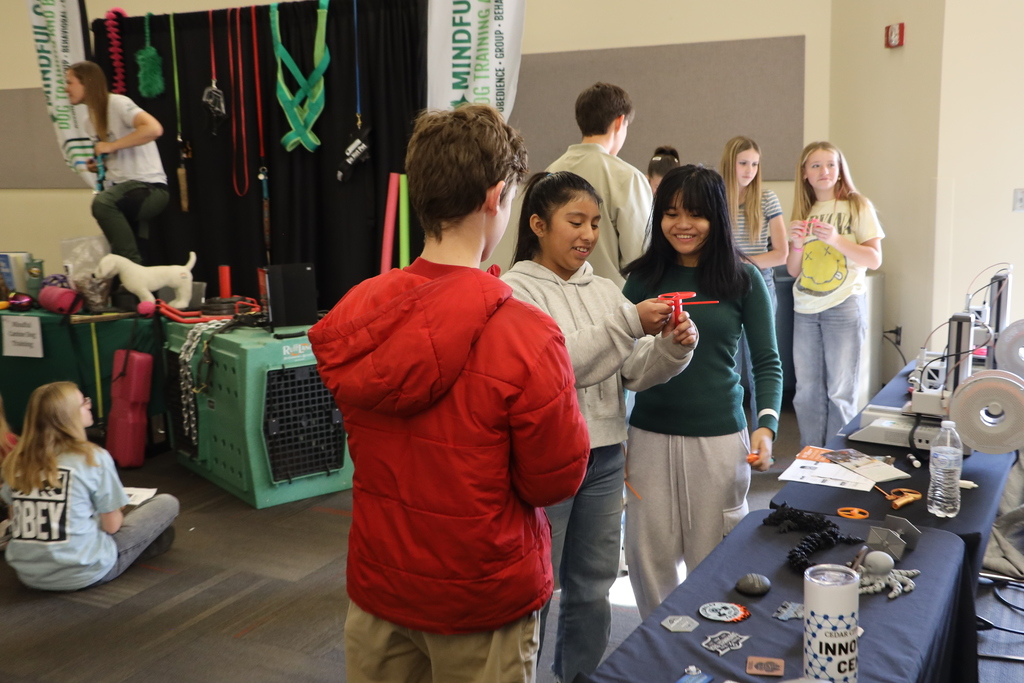 Students play with an item printed on a 3D printer.