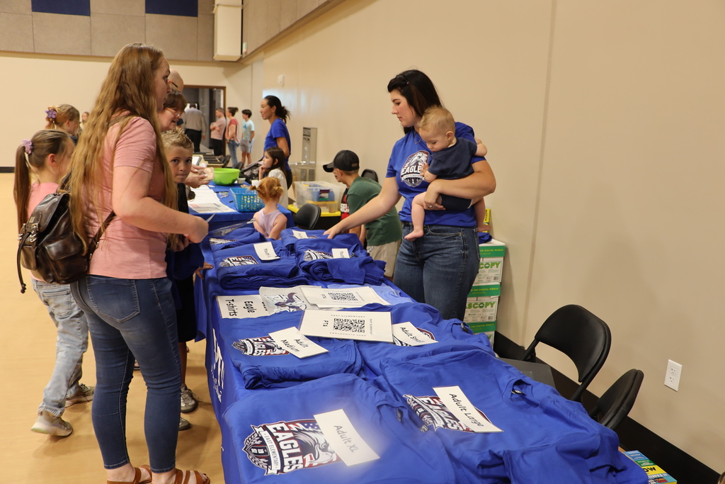 The PTA volunteers helped parents with T-shirts.