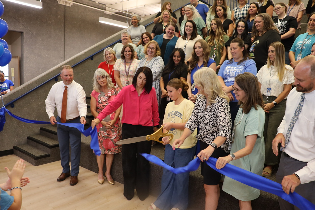 Fifth-grade student Jamie cuts the ribbon at East.