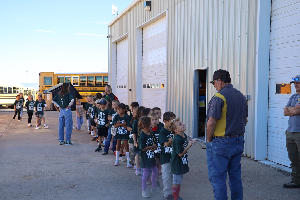 Students line up to go through three rotations at the bus garage.