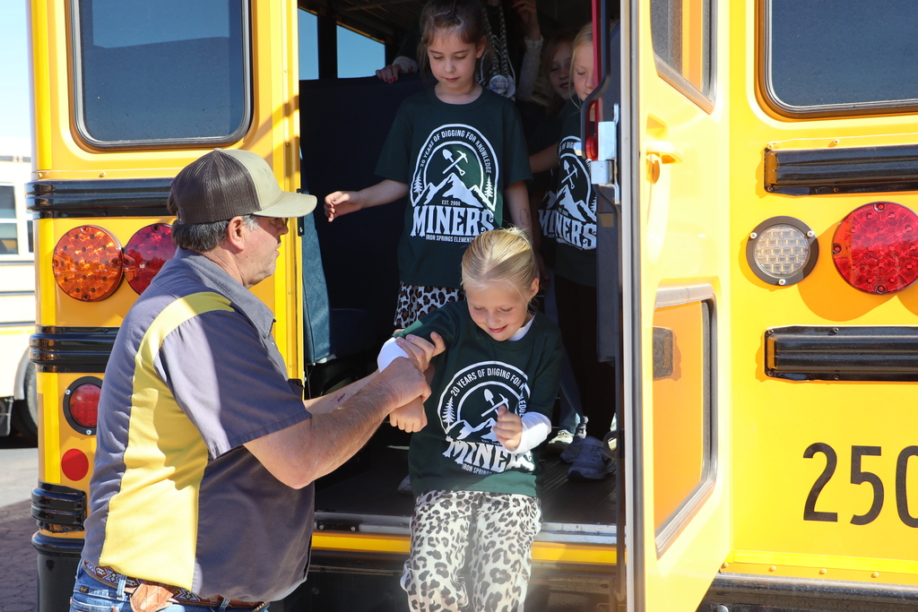 Students practice an emergency exit from the bus.