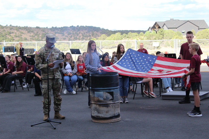 students holding the flag