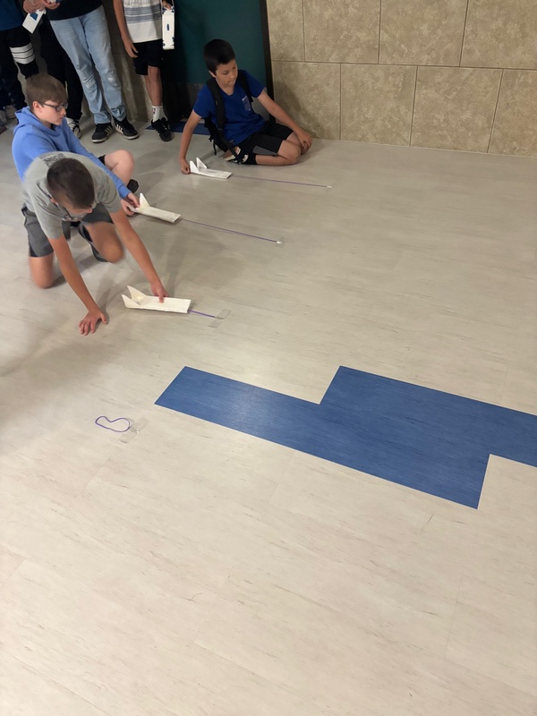 students racing skimmers