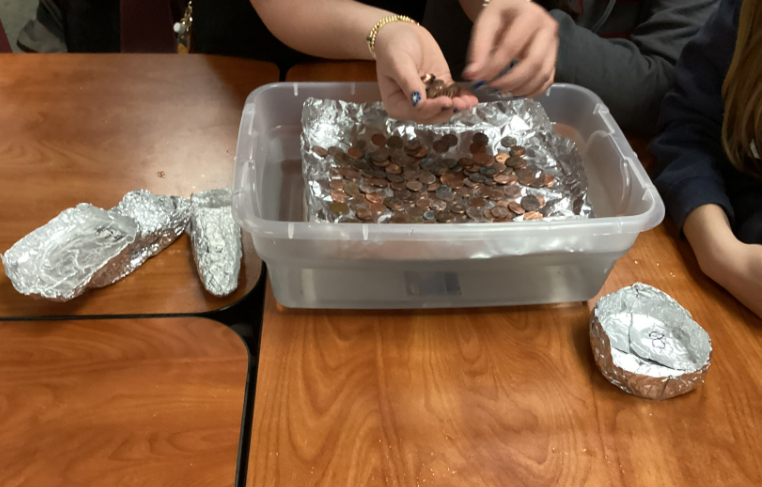 tin foil boat with pennies