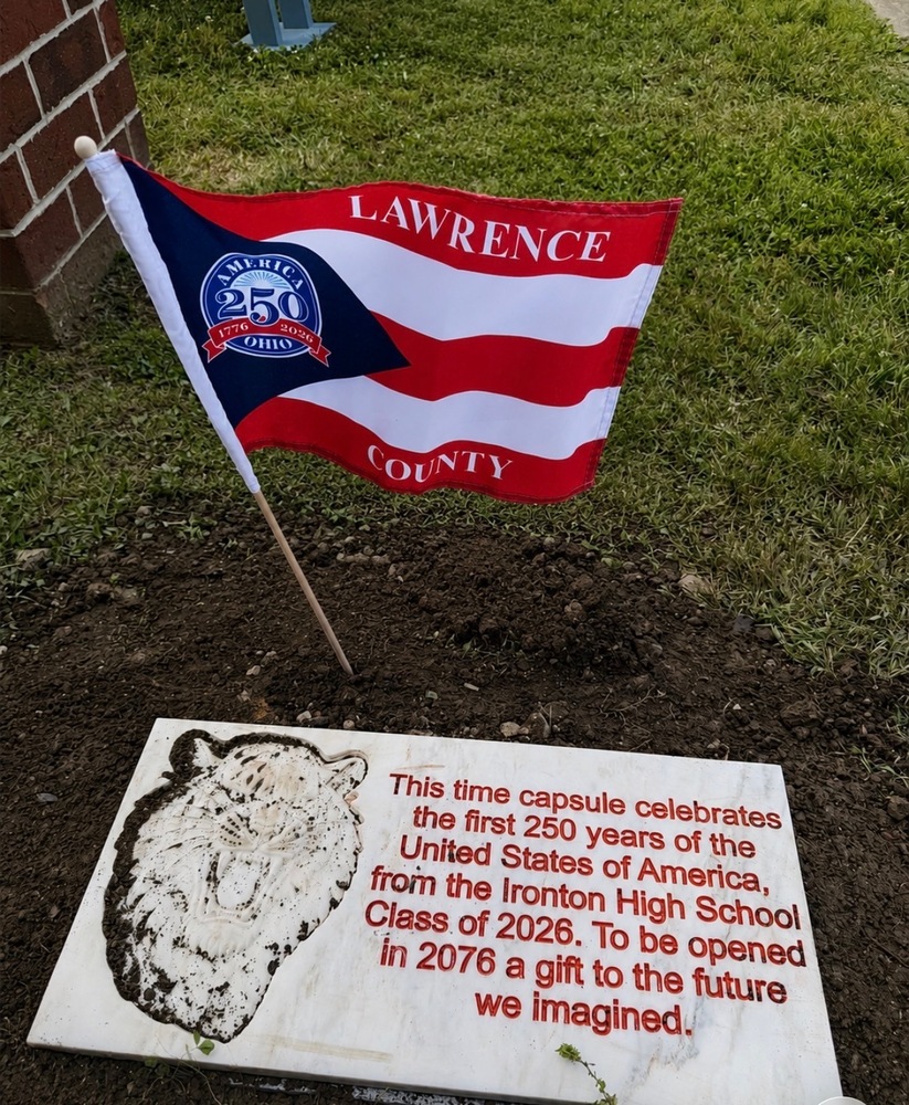 Pictured: Lawrence County America 250 flag above Ironton High School dedication block. Inscription reads: This time capsule celebrates the first 250 years of the United State of America, from the Ironton High School Class of 2026. To be opened in 2076 a gift to the future we imagined.