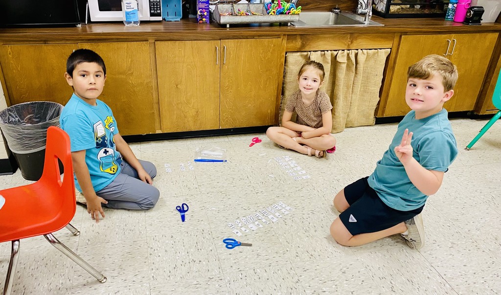 students worked in groups using domino cutouts to explore number combinations