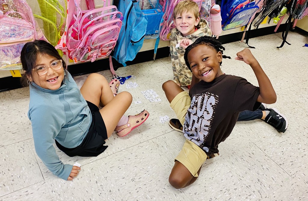 students worked in groups using domino cutouts to explore number combinations