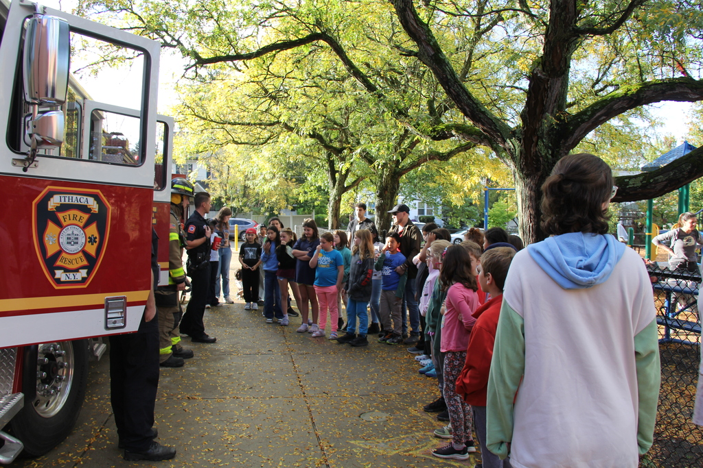 Students gather around the fire truck to ask questions about 