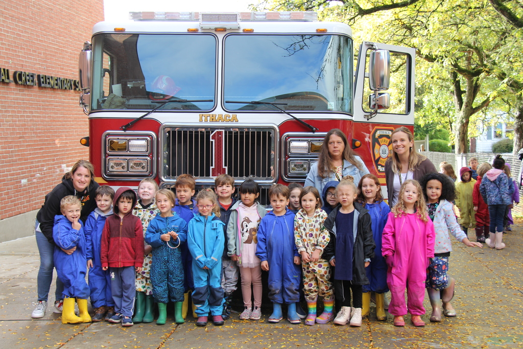 Kindergarten class stands outside Fall Creek in front of a fire truck 