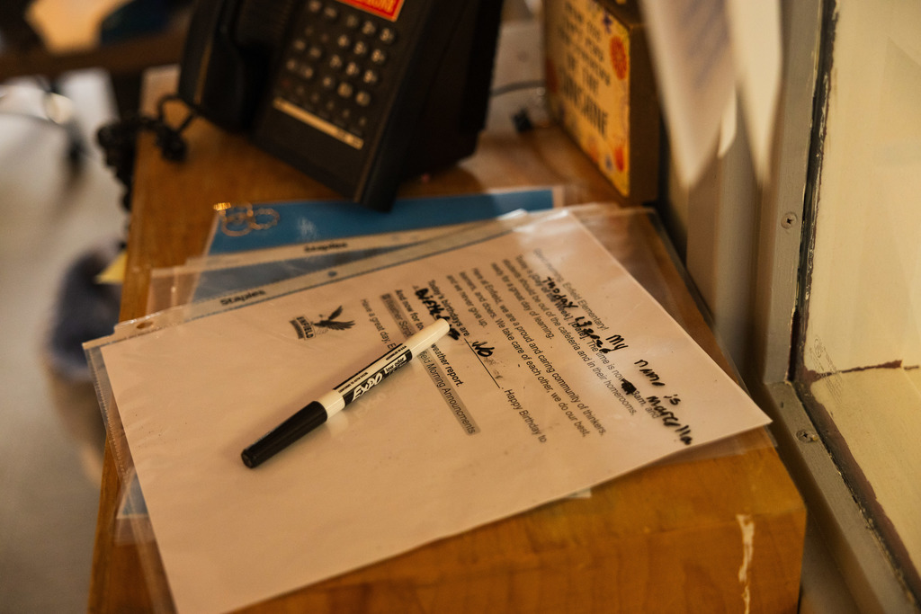 An image of the script on the desk next to the phone. A market sits on top. 