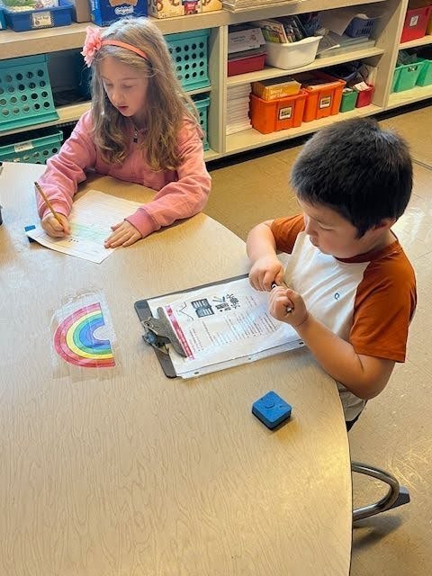 South Hill students peer reviewing their personal narratives with writing buddies. 