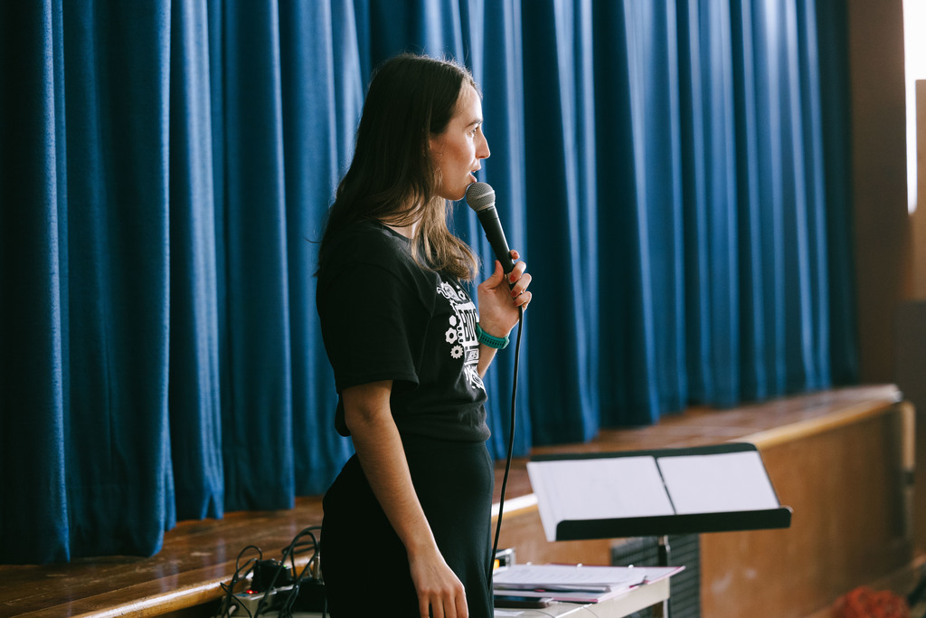 Elizabeth Dawson, director of BOTS!, talking to the audience into a mic.