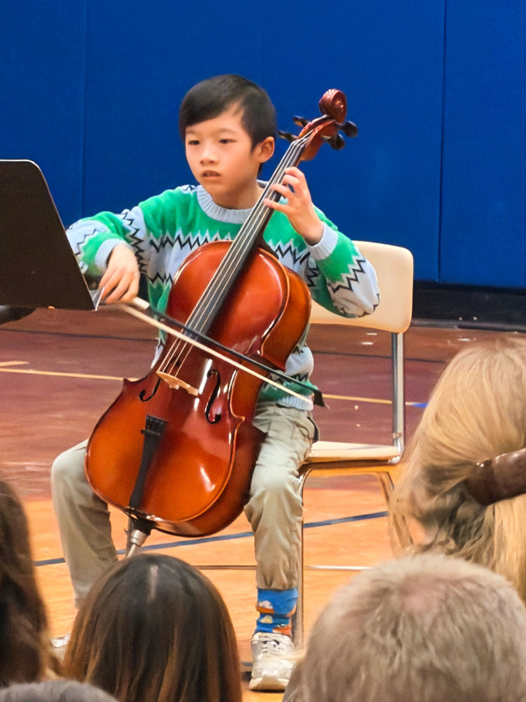 Student in the gym playing the cello