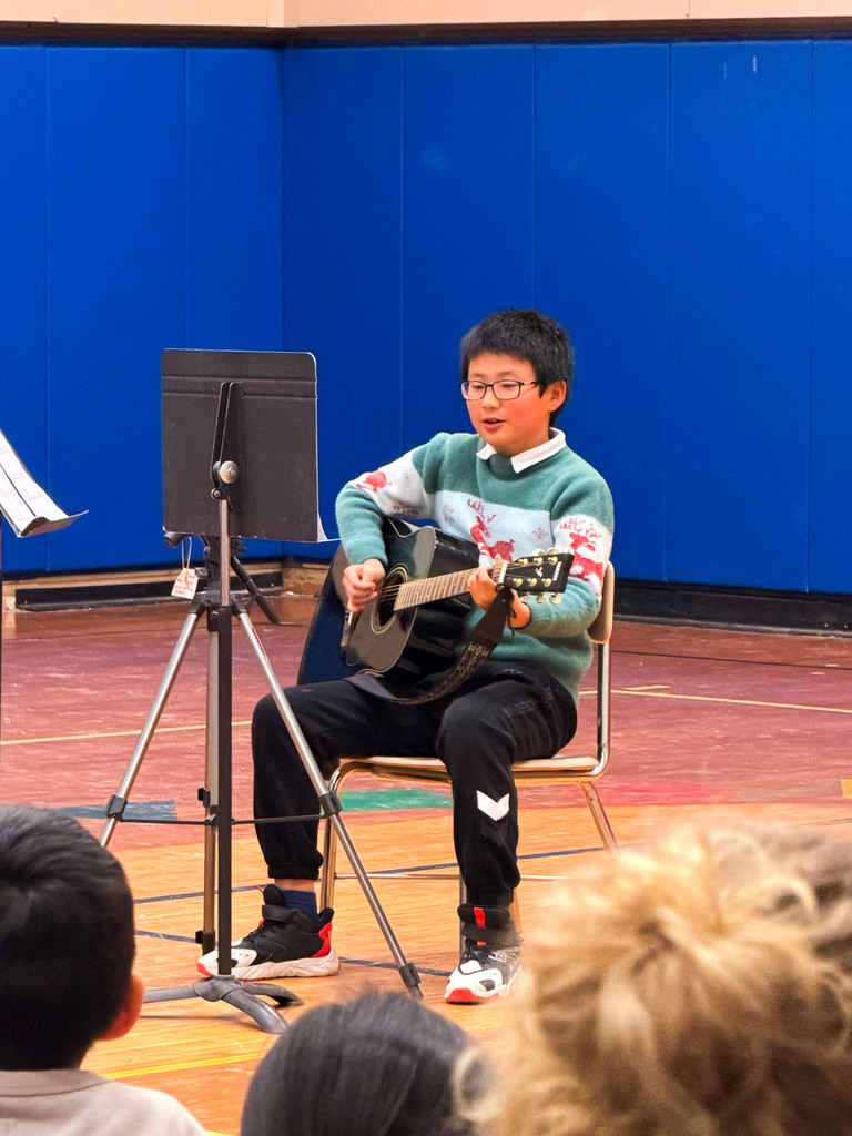 Student in the gym playing the guitar