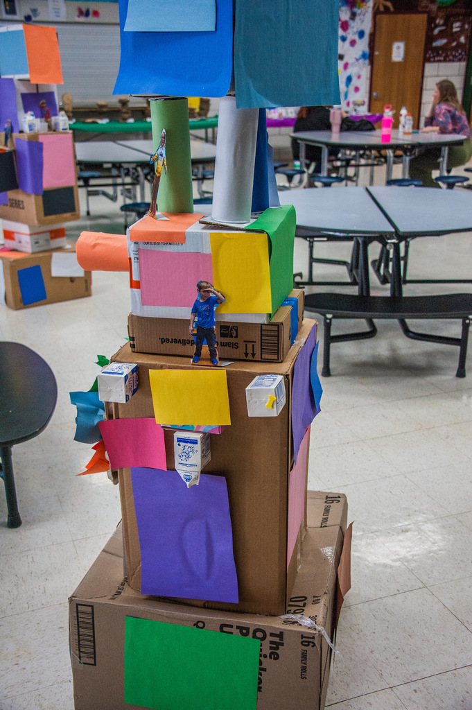 Cardboard boxes stacked on top of one another with colorful construction paper glued to it.