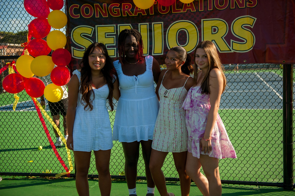 The four seniors on the girl tennis team pose for a photo