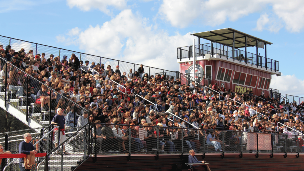 Stadium filled with many spectators, bleachers mostly occupied.