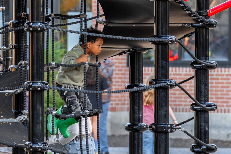 At student climbs on a jungle gym