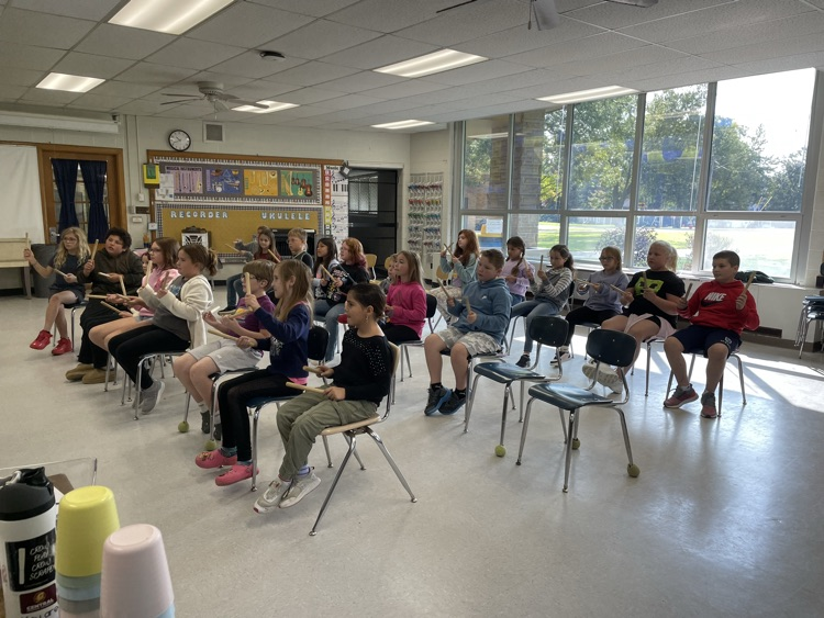 students playing rhythm sticks