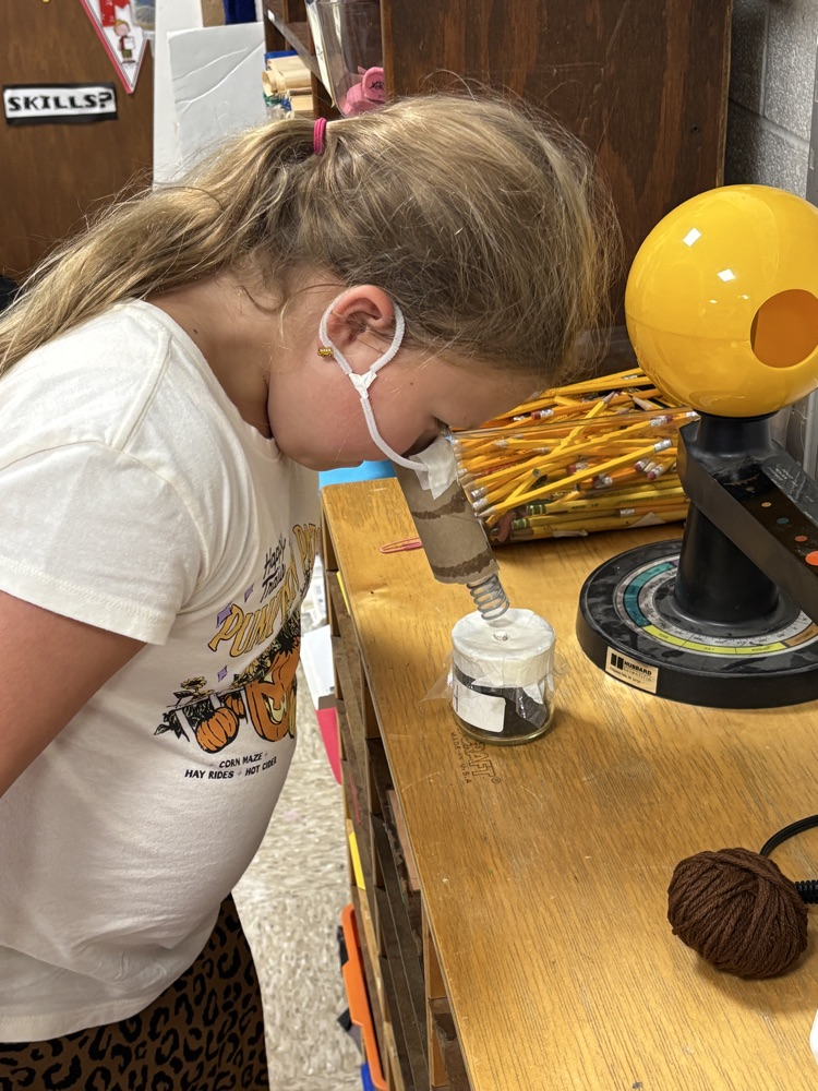 student smelling jar