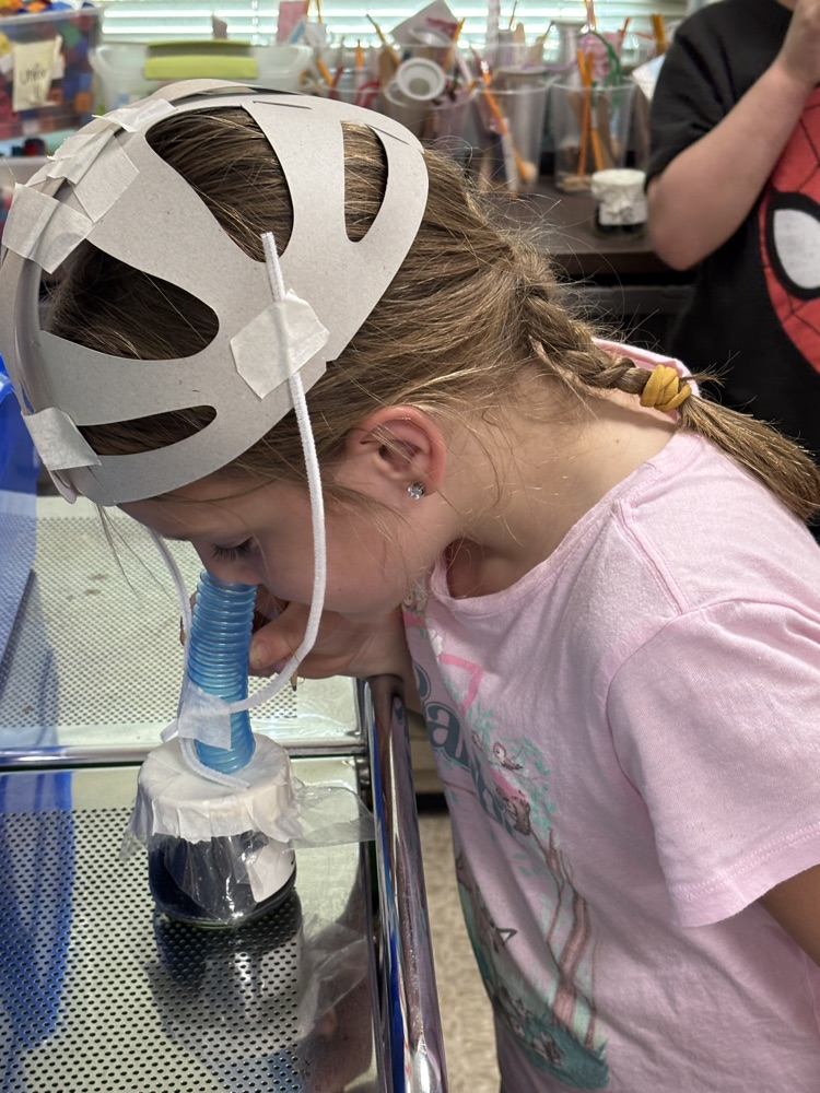 student smelling jar